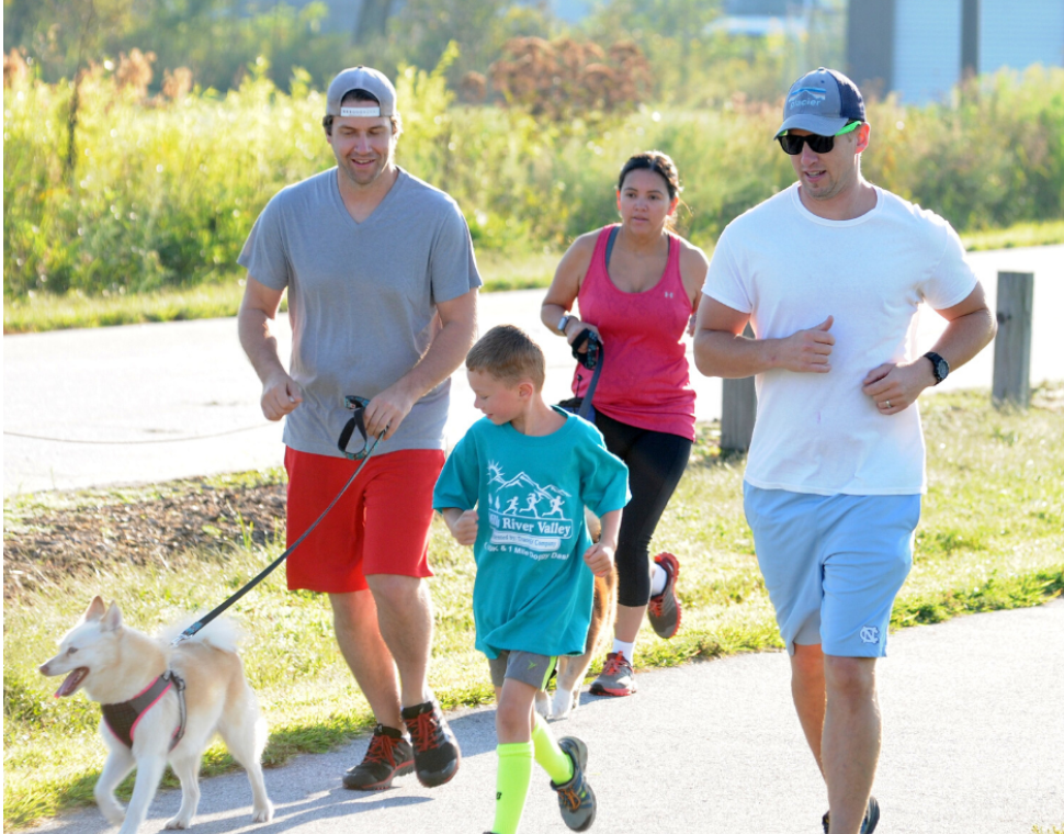 people and dog running